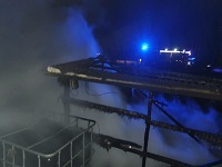 Zdjęcie kolorowe. Na zdjęciu zrobionym w nocy widać zgliszcza spalonej altany.