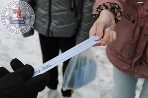 Zdjęcie kolorowe. Zbliżenie na element odblaskowy założony na rękę