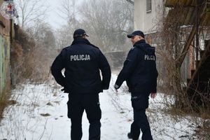 Zdjęcie kolorowe. Policjanci kontrolują pustostany