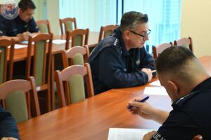 Zdjęcie kolorowe. Dzielnicowi podczas pisania testu